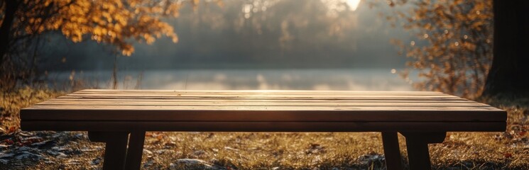 A tranquil scene featuring a rustic wooden table surrounded by autumn foliage near a serene lake, bathed in warm sunlight, perfect for relaxation.