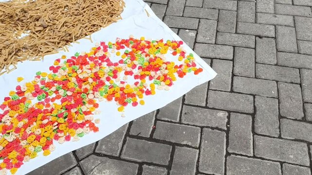 Raw Unfried Crackers Drying on White Trays Under Sunlight for Traditional Food Production