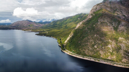 Dark lakes between the mountains of Tasmania on a cloudy day, seen from above