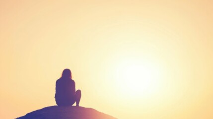 Traveler relaxing on mountain peak with solarpowered smartphone charging