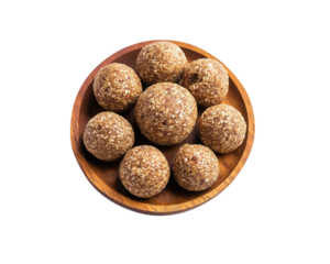 A pile of flax seed laddus on a wooden plate, Sweets laddu on Png Format and Transparent Background