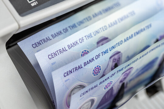 UAE money, Counting machine Emirates banknotes of 50 dirhams. Financial concept. Converting revenue, currency exchange, business and economy, AED symbol. close up