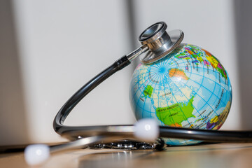 Universal Health Care Symbol: Stethoscope Wrapped Around World Signifying Global Medical Unity And...