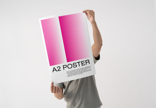 Mockup Of Man Holding A2 Customized Poster Over Face