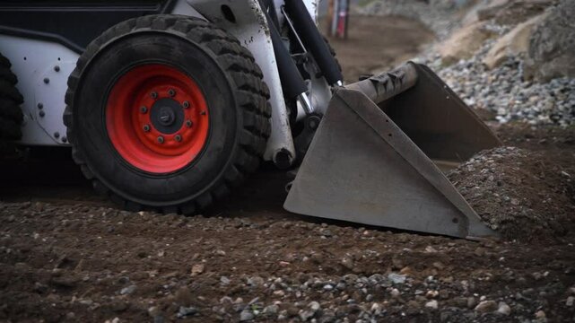 Mini excavator leveling the dirt