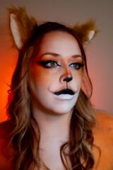 Model with makeup reminiscent of an orange fox.