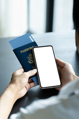 hand holding empty screen smartphone with passport.