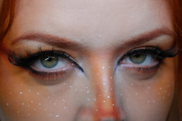 Model with makeup reminiscent of an orange fox.