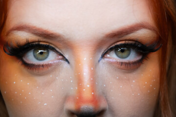 Model with makeup reminiscent of an orange fox.
