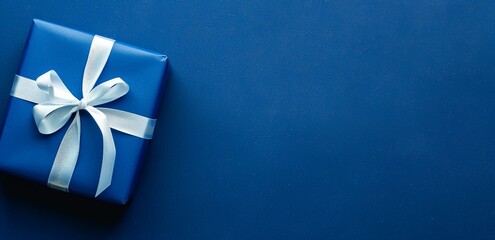 Blue present with white bow placed on dark blue background