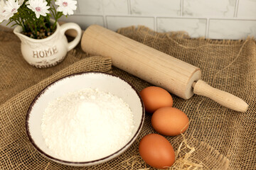 Eggs, flour and rolling pin. Homemade pastries. Dough Ingredients