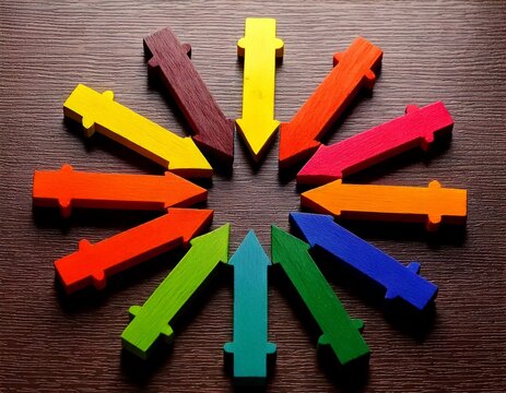 colorful wooden arrows pointing to the same central point isolated on black background inward inwards direction focus convergence converge