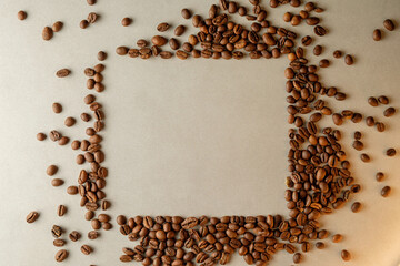 Coffee beans arranged creatively on a surface form an empty frame