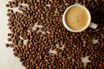 Rich coffee beans surround a steaming cup of freshly brewed beverage