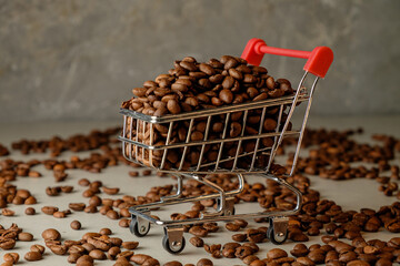 Unloading roasted coffee beans in a mini shopping cart on a light surface