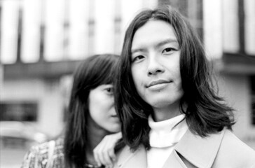 Young asian couple posing together in monochrome, vintage style portrait