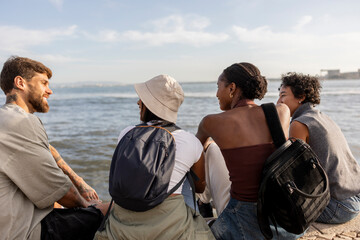 Group of diverse friends enjoying a relaxing day by the sea