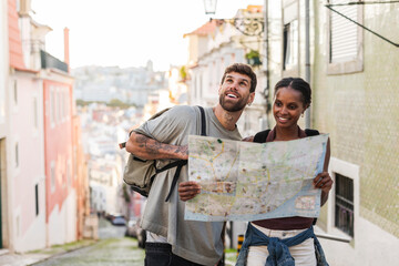 Tourists holding map exploring lisbon, portugal, europe