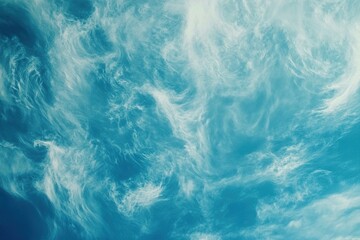 Obraz premium Soft white clouds drift across a bright blue sky on a clear day