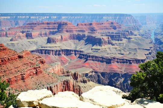 Majestic canyon vista, layered rock formations, vibrant hues of red, beige, and white, showcasing immense depth and scale