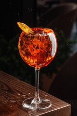 Aperol spritz cocktail in a glass with ice and orange, minimal trendy shot. Alcohol aperol spritz aperetivo