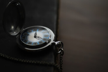 Vintage Pocket Watch on Dark Surface, Timeless Elegance and Antique Charm in Low Light