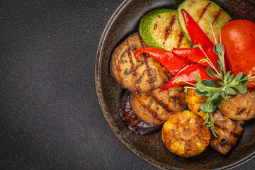 Grilled vegetables in plate colorful bell pepper, zucchini, eggplant on a dark background. top view. copy space for text