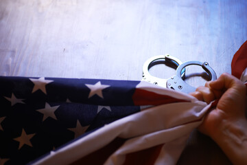 American Flag Gripped with Handcuffs - Concept of Freedom and Restriction in the United States