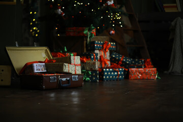 Cozy Christmas Living Room with Open Suitcase and Wrapped Gifts Under a Decorated Tree