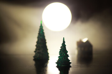 Festive Winter Scene with Miniature Trees and Moonlit Background