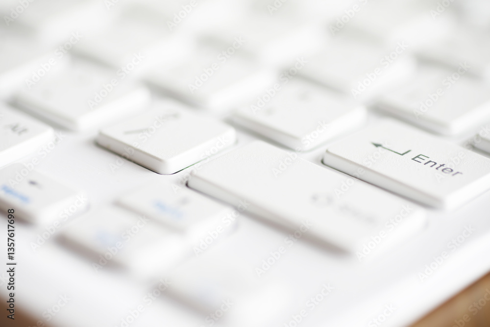 Aufkleber close-up shot of a white computer keyboard with blurred background for modern office settings