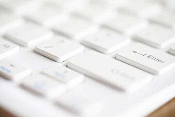 Close-Up Shot of a White Computer Keyboard with Blurred Background for Modern Office Settings