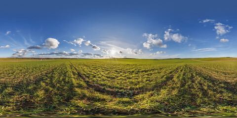spherical 360 hdri panorama on agro field with clouds and sun on blue sky in equirectangular...