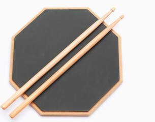 Drums rubber pad and wooden sticks isolated on white. Music school education kit.