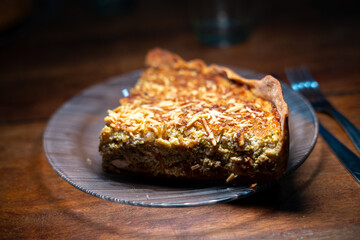 Sideview of a slice of a vegetarian pie on a glass plate