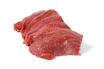 Multiple raw steaks arranged on a white background