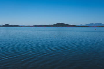Calm blue lake with distant mountains