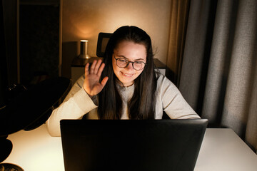 Smiling friendly female freelancer having online conference call with client sitting at home....
