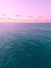 Aerial view of colorful sunset over ocean in Punta Cana.Breathtaking scenery showcases sky painted with stunning hues, while gentle waves reflect evening light. Postcard capturing beauty of tropical