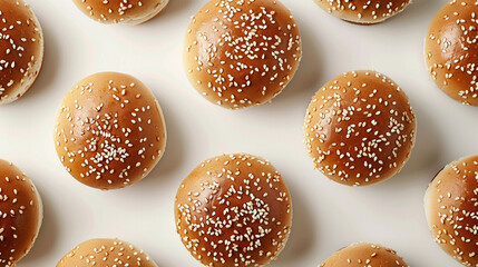 Flat lay of sesame seed burger buns arranged in a clean row, bakery-style presentation for gourmet sandwich use