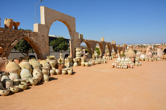 A vast array of pottery and terracotta items displayed outdoors. A pottery market in Guellala, the village of potters in Tunisia.