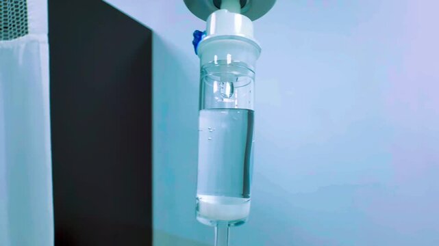iv drip drops into the patient's room Closeup Saline solution or NSS fluid from IV bag NSS iv dripping tube infusion pumping in hospital chemotherapy
