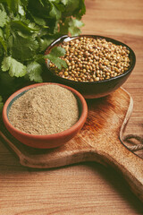 a bunch of fresh cilantro, coriander seeds and powder bowls, close-up, top view, no people, food and drinks,
