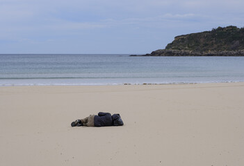 Man lying on the beach.