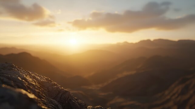 A serene sunset over a mountainous landscape, casting warm hues across the sky and illuminating the rugged terrain.