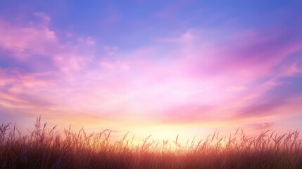 A serene sunset painting the sky in shades of pink and purple, silhouetted by tall grass in the foreground.
