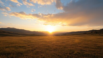 A breathtaking sunset over rolling hills, with golden light illuminating the landscape beneath a vibrant sky filled with clouds.