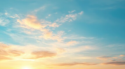 Obraz premium A serene sky at sunset with soft clouds and warm hues, creating a peaceful and calming atmosphere.