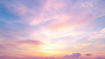 Fototapeta premium A serene sky at sunset, painted in soft hues of pink, orange, and blue, with wispy clouds adding to the tranquil atmosphere.