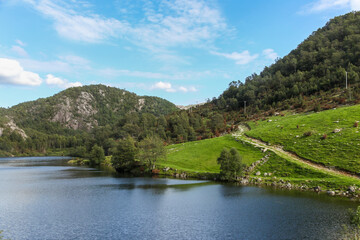 Fototapeta premium A calm lake with a mountain in the background in Norway fjord land